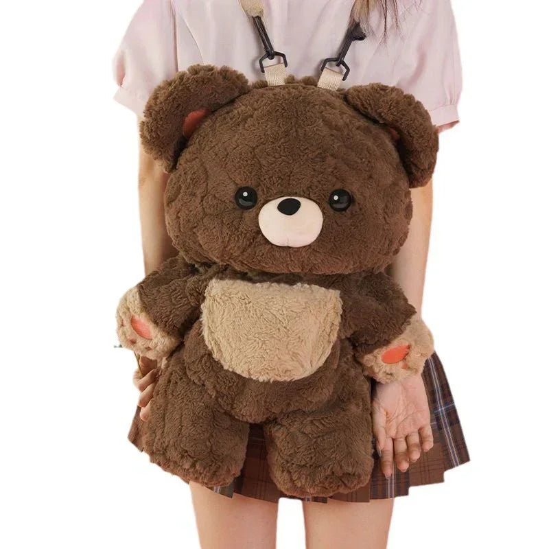 Brown plush teddy bear backpack with soft texture, worn over plaid skirt and light top.