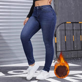 Woman wearing high-waisted dark blue skinny jeans with fleece lining, casual street style