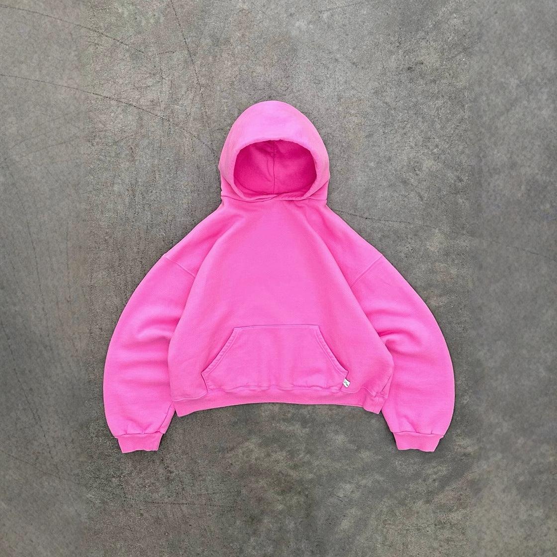 Oversized pink hoodie with front pocket, soft fleece material, relaxed fit, streetwear style