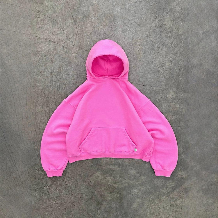 Oversized pink hoodie with front pocket, soft fleece material, relaxed fit, streetwear style