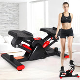 Woman in black sporty crop top and shorts using compact home stepper exercise machine