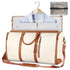 Cream and brown leather travel garment bag with shoulder strap, suit inside, and mesh accessory pouch