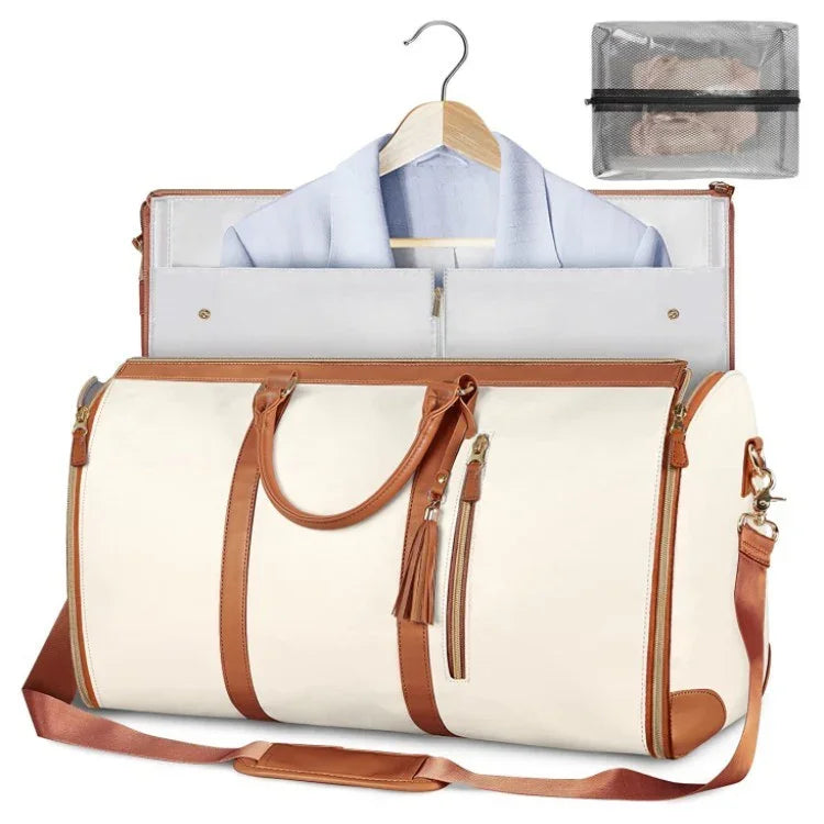 Cream and brown leather travel garment bag with shoulder strap, suit inside, and mesh accessory pouch
