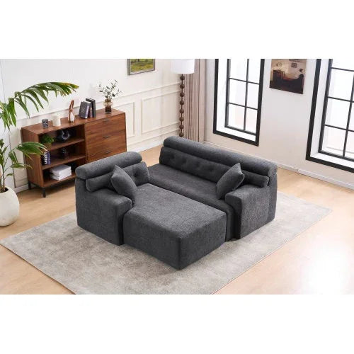 Modern gray fabric sofa with adjustable backrest and armrests in a bright living room
