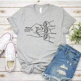 Light gray short sleeve graphic tee with mother and child hand illustration, paired with distressed denim shorts. Casual, relaxed fit streetwear style.