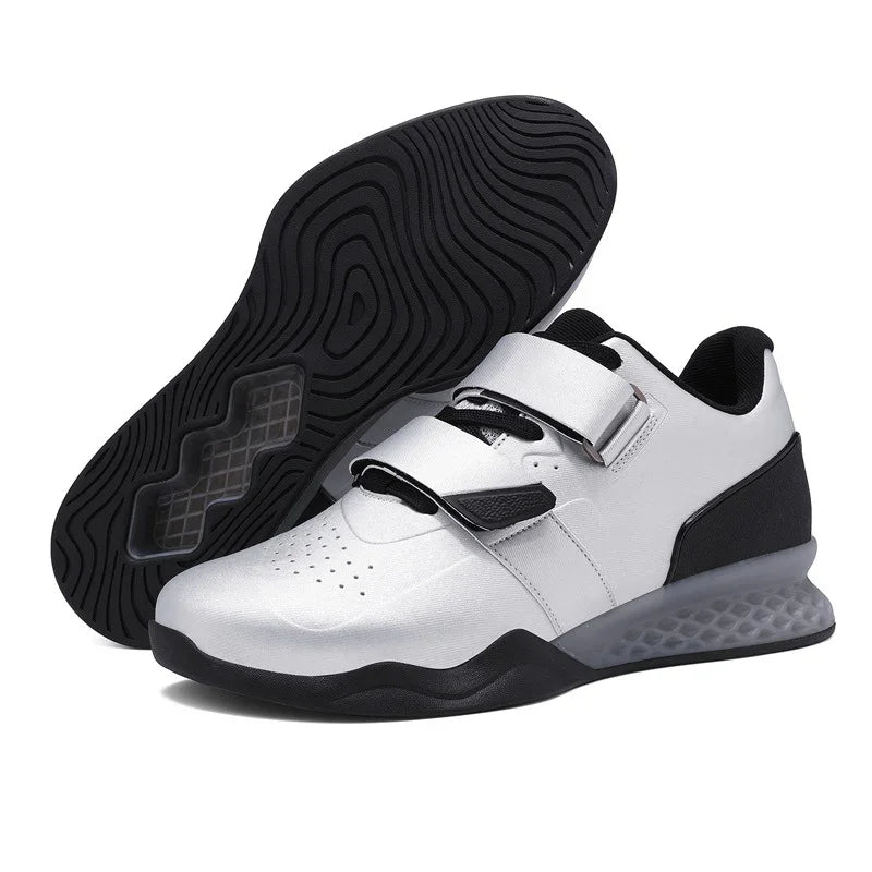 Modern white and black low-top sneakers with velcro straps and textured sole