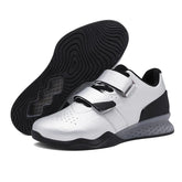 Modern white and black low-top sneakers with velcro straps and textured sole