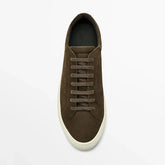 Brown suede low-top sneaker with flat laces and white rubber sole, casual streetwear style