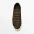 Brown suede low-top sneaker with flat laces and white rubber sole, casual streetwear style