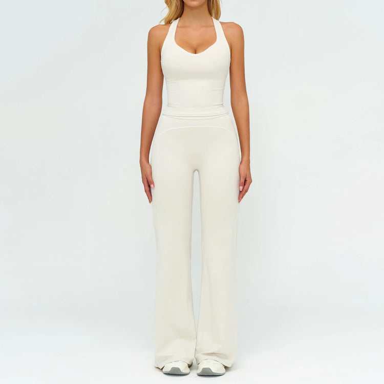 Woman wearing fitted cream halter jumpsuit with flared legs, modern streetwear style