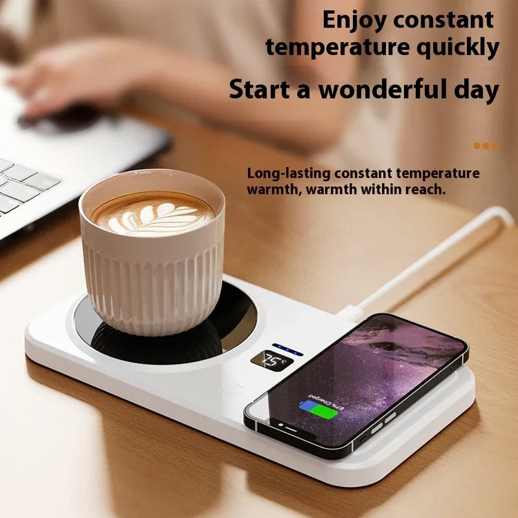 White ceramic mug with coffee on a desk mug warmer and smartphone wireless charging pad.