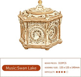 Intricate wooden mechanical music box puzzle with Swan Lake theme, laser-cut details, hexagonal shape.