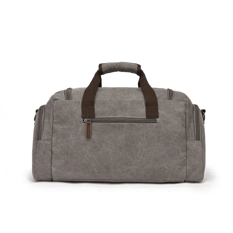 Gray canvas duffel bag with brown handles and multiple zippered pockets, minimalist style