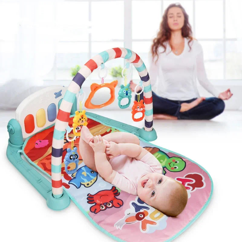 Baby on colorful play mat with animal print and hanging toys, woman meditating in background