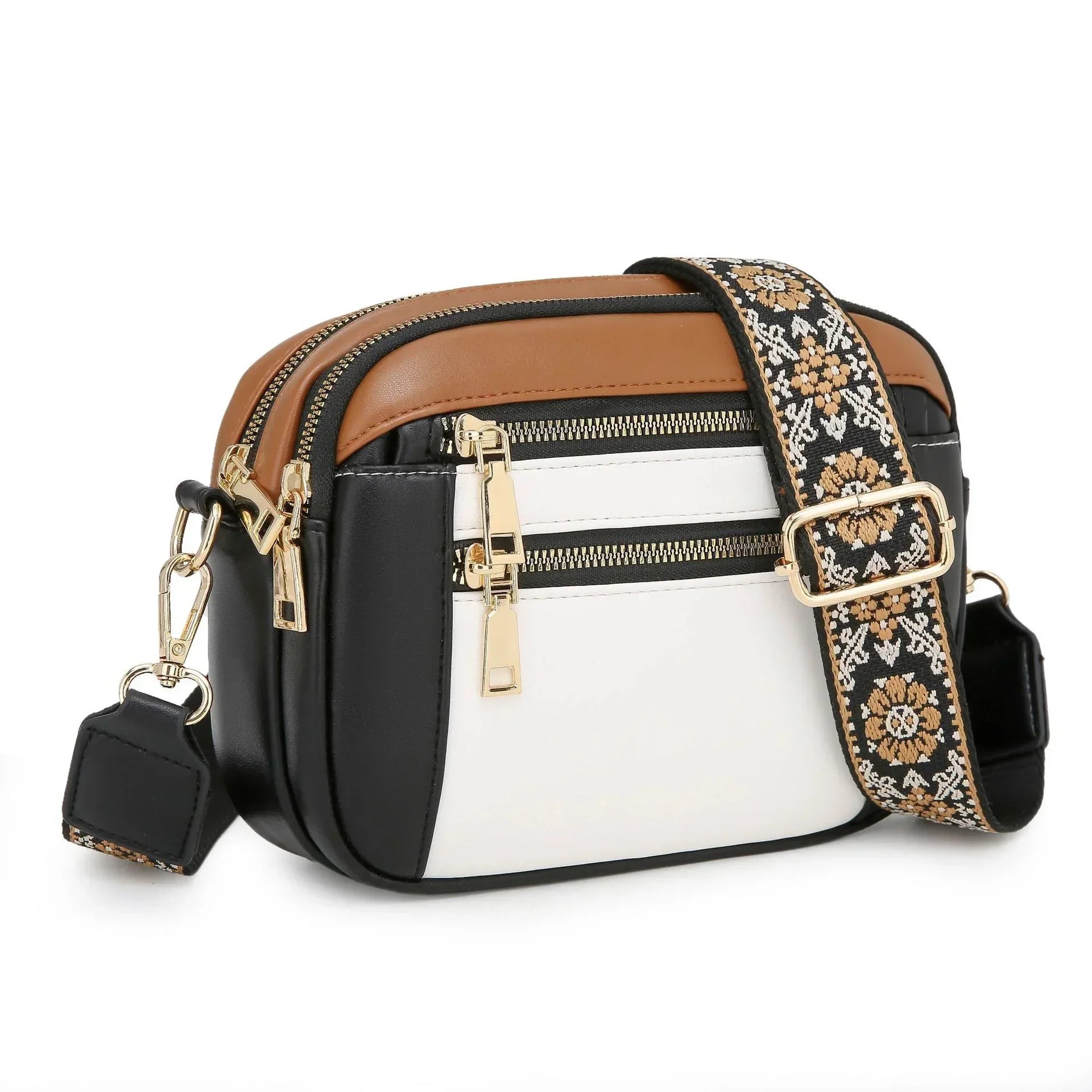 Colorblock crossbody bag with black, white, and brown faux leather, gold zippers, floral strap
