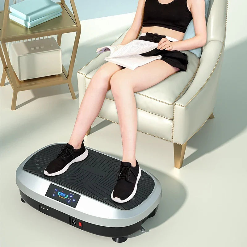 Woman in black crop top and shorts, relaxed fit, using vibration platform machine indoors