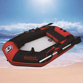 Red and black inflatable boat with oars on sandy beach, durable PVC material, spacious fit