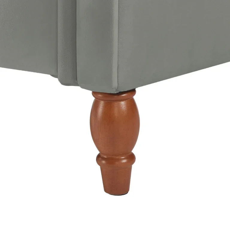Light grey upholstered furniture with wooden turned leg, close-up detail