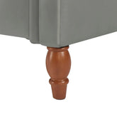Light grey upholstered furniture with wooden turned leg, close-up detail
