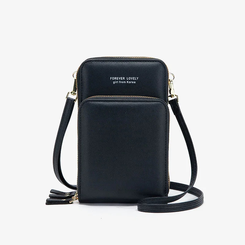 Black faux leather crossbody bag with adjustable strap and gold zipper details