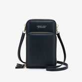 Black faux leather crossbody bag with adjustable strap and gold zipper details