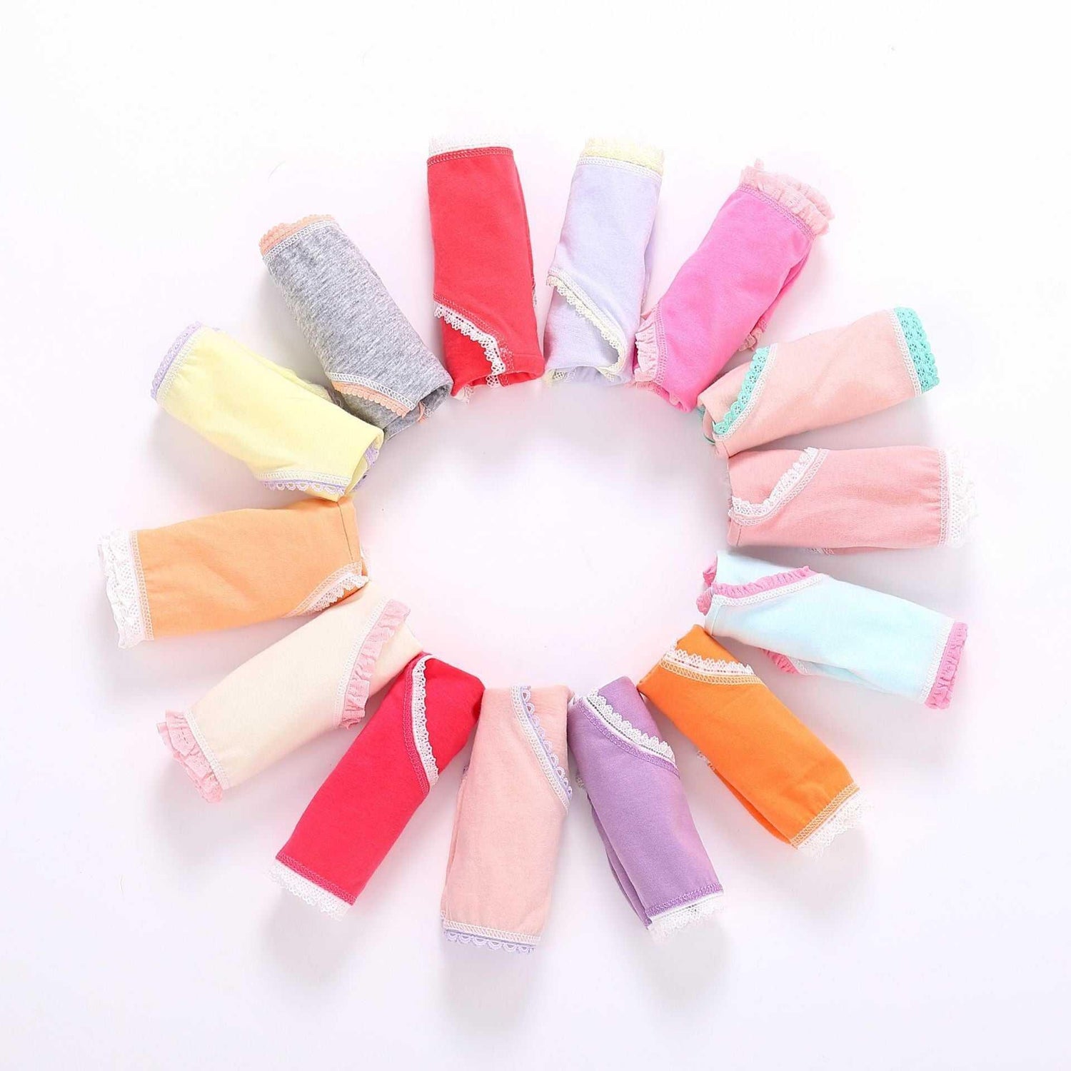 Assorted pastel and bright cotton underwear with lace trim arranged in a circle