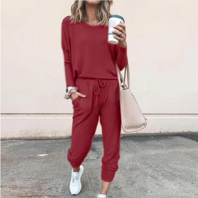 Woman in relaxed fit red lounge set, long sleeve top and jogger pants, casual streetwear style