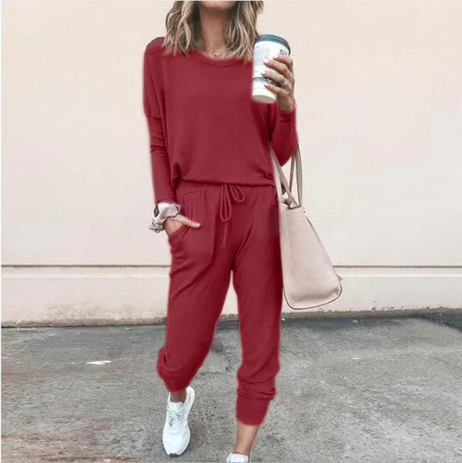 Woman in relaxed fit red lounge set, long sleeve top and jogger pants, casual streetwear style