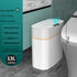White 13L rectangular smart trash can with touchless sensor, waterproof design, and orange accent in a modern bathroom.
