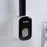 Modern black and white wall-mounted toothpaste dispenser in bathroom setting