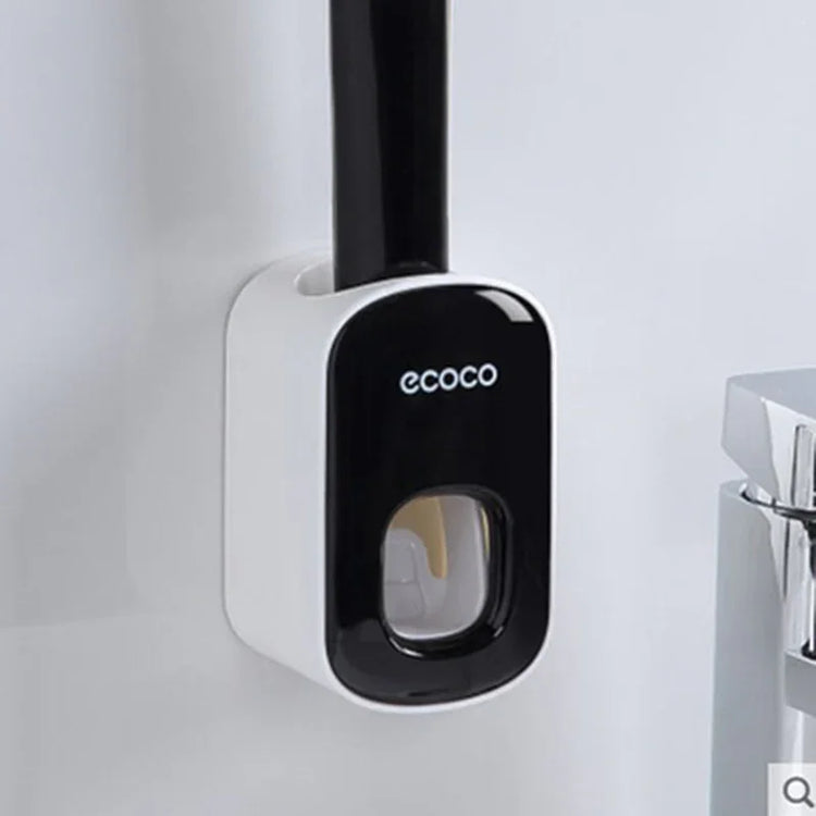 Modern black and white wall-mounted toothpaste dispenser in bathroom setting