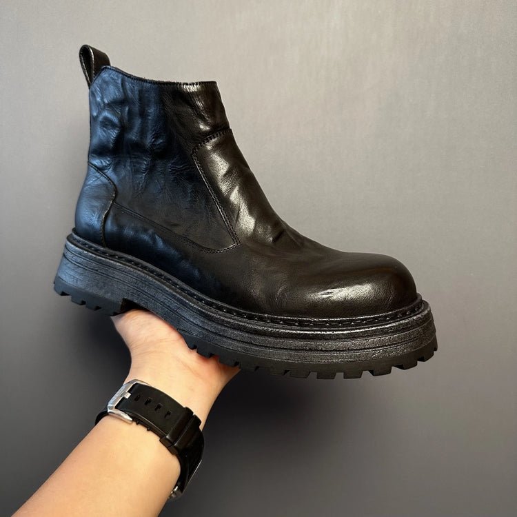 Modern black leather ankle boot with chunky sole, minimalist design, and smooth finish