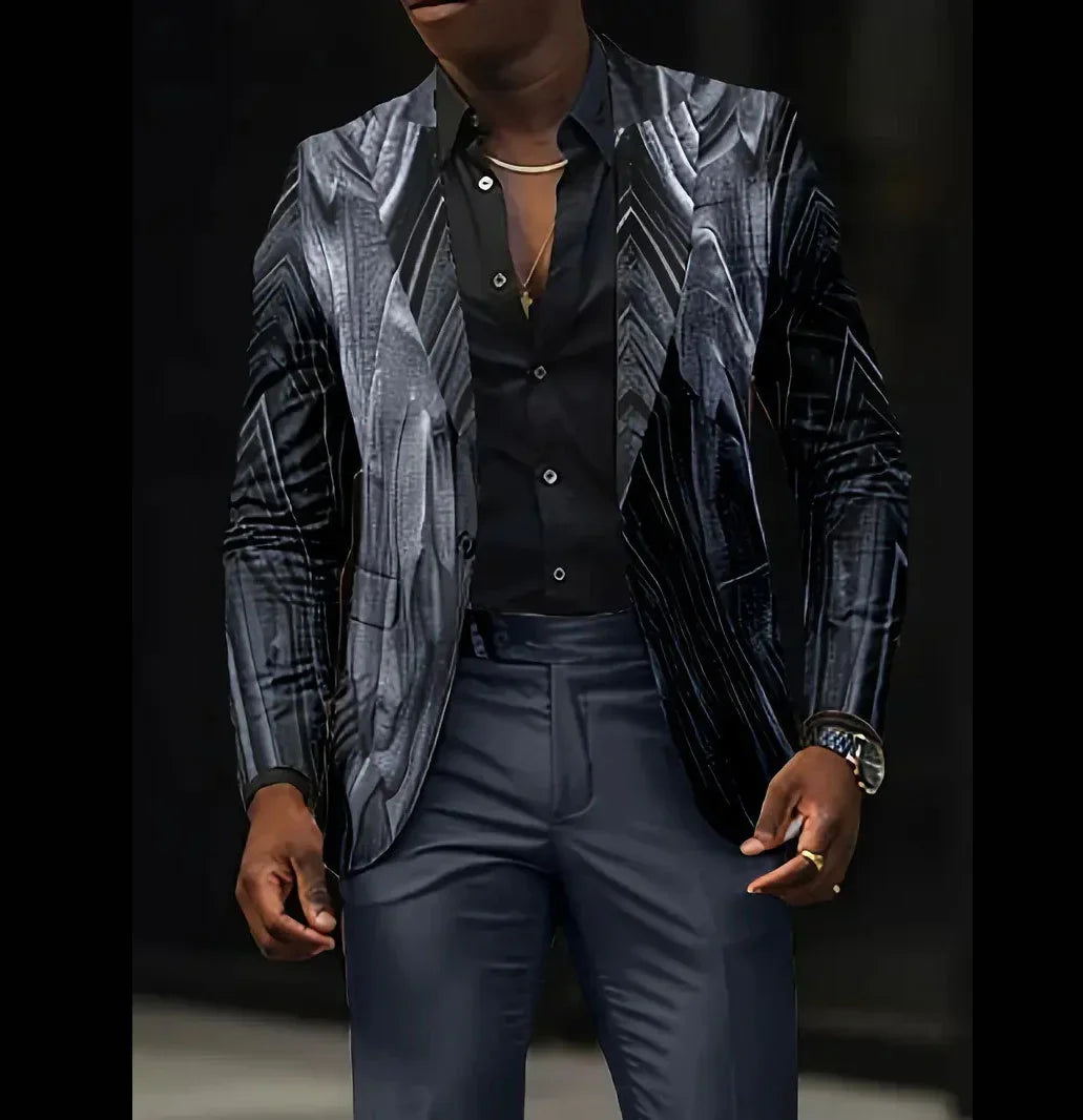 Man wearing a fitted metallic silver and black patterned blazer, black dress shirt, and dark trousers