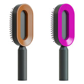 Two oval hairbrushes with unique hollow centers, one brown and one pink, black handles