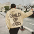 Beige oversized streetwear hoodie with bold graffiti text, relaxed fit, outdoor urban setting
