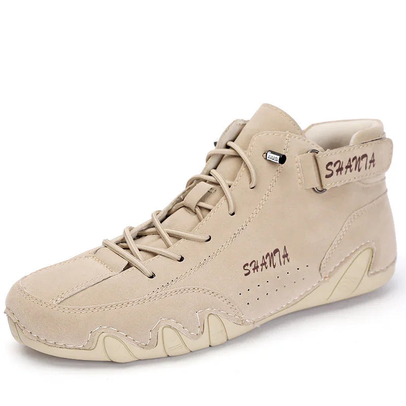 Beige suede high-top sneaker with lace-up front, ankle strap, and cushioned sole