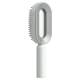 Modern white and gray oval hair brush with vented design and ergonomic handle