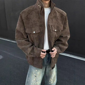 Oversized brown suede jacket with buttoned front pockets, relaxed fit, paired with distressed jeans