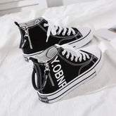 Black canvas high top sneakers with white laces, side zipper, and bold graphic text, casual fit