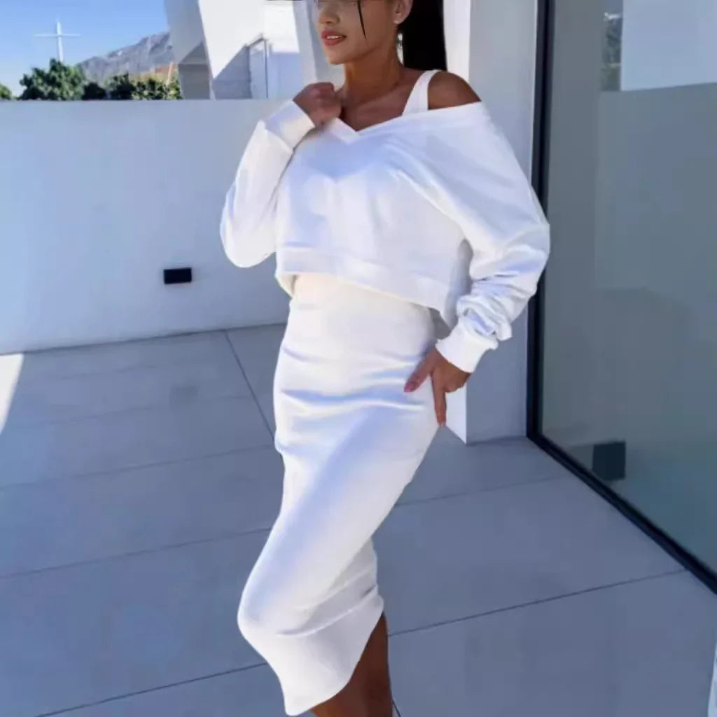 Woman wearing white off-shoulder crop sweatshirt and fitted midi skirt, modern streetwear style