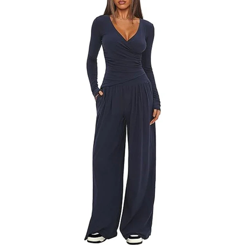Woman wearing navy blue long sleeve wide-leg jumpsuit, soft fabric, relaxed fit