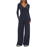 Woman wearing navy blue long sleeve wide-leg jumpsuit, soft fabric, relaxed fit