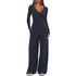 Woman wearing navy blue long sleeve wide-leg jumpsuit, soft fabric, relaxed fit