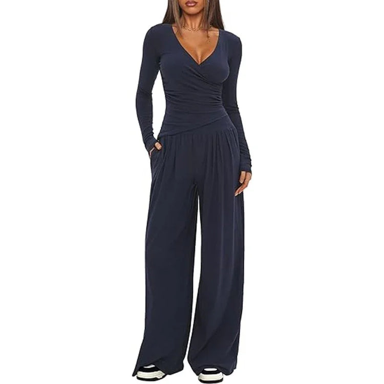 Woman wearing navy blue long sleeve wide-leg jumpsuit, soft fabric, relaxed fit