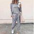 Woman wearing gray casual lounge set with heart graphic, drawstring joggers, and white sneakers