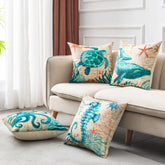 Beige linen sofa with ocean-themed throw pillows featuring teal sea turtle, whale, octopus, and seahorse prints, modern living room decor.