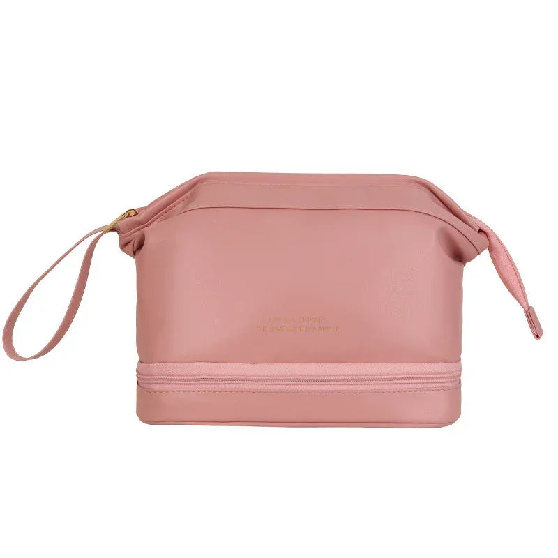 Pink leather toiletry bag with gold zipper and wrist strap, modern minimalist style