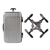 Metallic gray hard-shell suitcase and compact foldable drone with black propellers