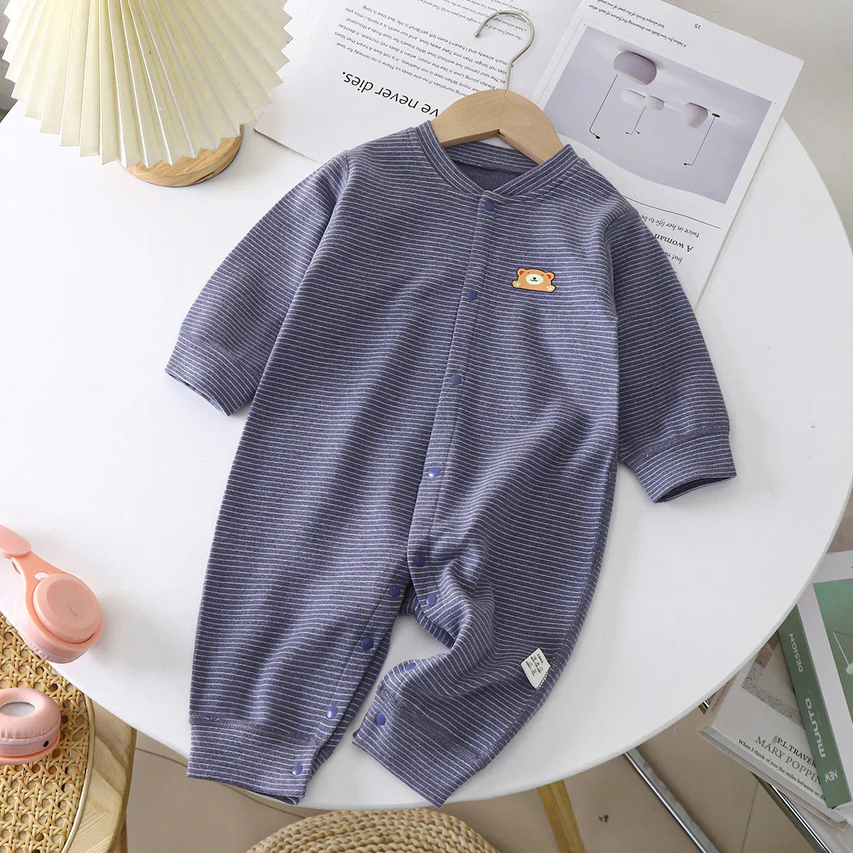 Long-sleeve purple striped baby romper with snap buttons and a small bear patch, cotton material, loose fit