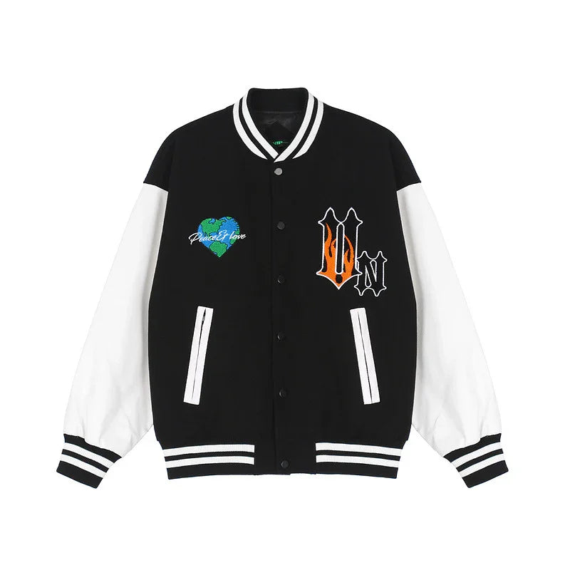 Black and white varsity jacket with bold patches, striped cuffs, and relaxed fit streetwear style